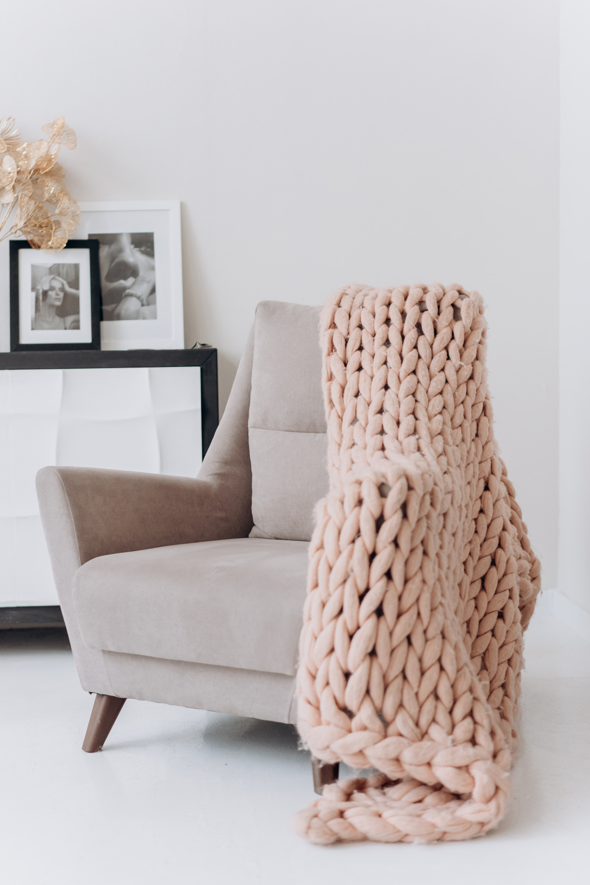 White and Brown Armchair Beside White Wall